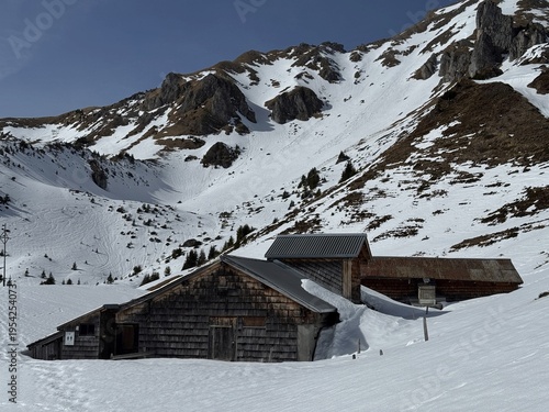 Old traditional swiss rural architecture and alpine livestock farms in the winter ambience of the alpine Swiss tourist resort Davos - Canton of Grisons, Switzerland (Kanton Graubünden, Schweiz)