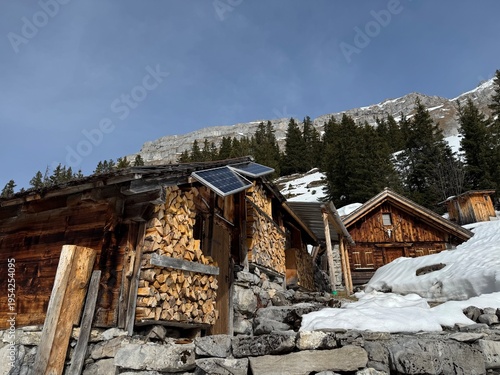 Old traditional swiss rural architecture and alpine livestock farms in the winter ambience of the alpine Swiss tourist resort Davos - Canton of Grisons, Switzerland (Kanton Graubünden, Schweiz)