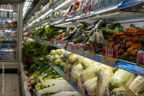 Wrapped vegetables on shelves in a supermarket aisle