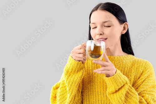 Young woman with glass cup ...