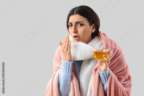Ill young woman with glass ...