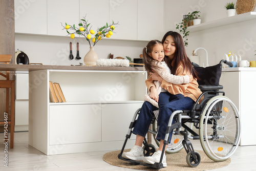 Young Asian mother in wheel...