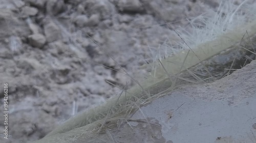 Close-up of a skilled artist using an angle grinder to cut and shape a fibre sculpture, captured in slow motion. The scene highlights precision craftsmanship, manual work, and industrial tools, India