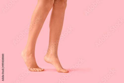 Legs of woman on pink backg...