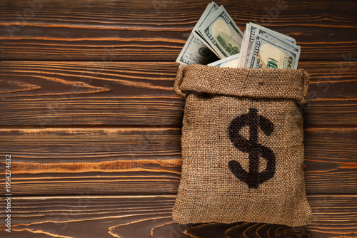 Bag full of money on wooden...