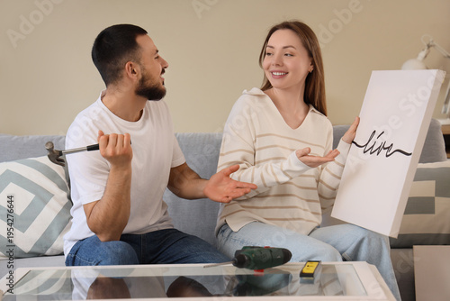 Young couple with poster si...