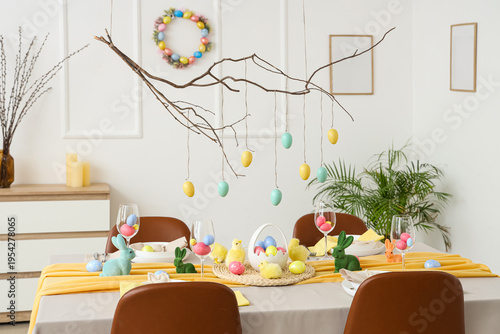 Interior of room decorated for Easter with dining table and tree branches