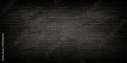 A detailed view of a dark charcoal gray brick wall with subtle lighting and a natural texture feel