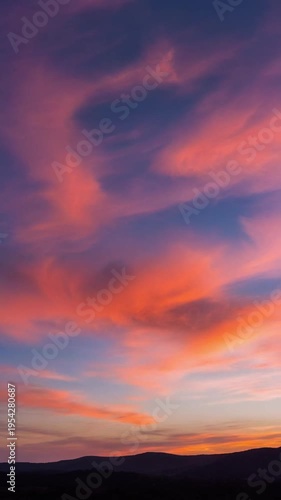 Wallpaper Mural Vibrant pink and orange clouds fill a serene evening sky at sunset over a mountainous landscape Torontodigital.ca