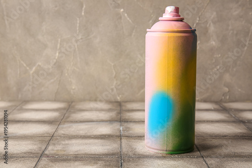 Spray paint can on grey til...