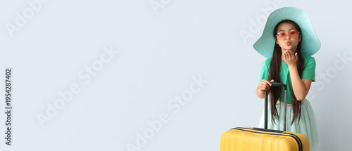 Cute little girl with suitc...