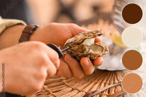 Man opening fresh oyster wi...