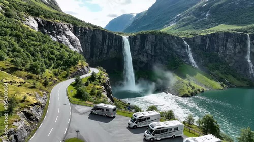 RV Campervans parked by a scenic waterfall road in green mountains