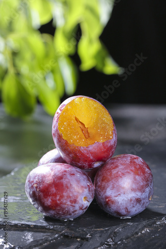 Fresh Ripe Plums Cut in Half Showing Sweet Golden Flesh - Studio Food Photography