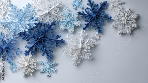 Decorative blue and white snowflakes on light background for winter designs