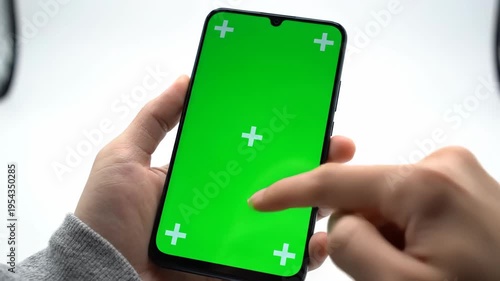 Using smartphone with green screen for app demo or user interface mockup