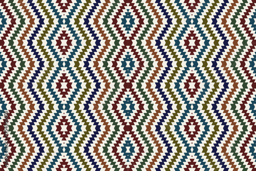 seamless geometric pattern with colorful zigzag diamond shapes. Ethnic tribal Navajo inspired motifs in earthy tones. Vector abstract repeating background for textile, rug, and interior design.