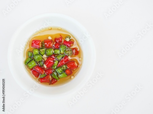 Obraz na plátně The chili paste with fish sauce is in a bowl placed on a white surface