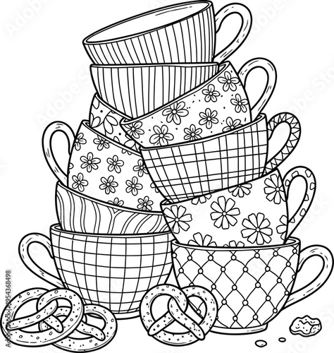 Stack of teacups with floral patterns and cookies