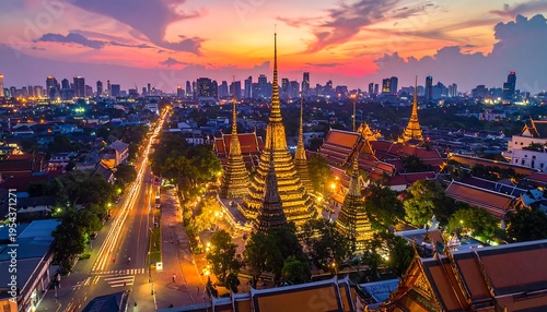 Wallpaper Mural Aerial view captures a city sunset over golden spired temples, illuminated buildings, and streaking headlights Torontodigital.ca