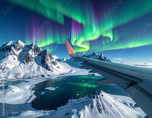 Wallpaper Mural Aerial view from an airplane window showcasing the Northern Lights over snow-covered mountains, a bay, and the sea Torontodigital.ca