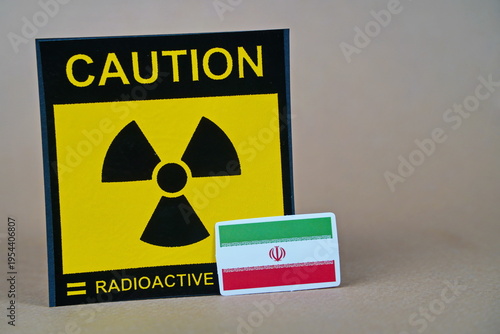The symbol of radioactivity and the flag of Iran.