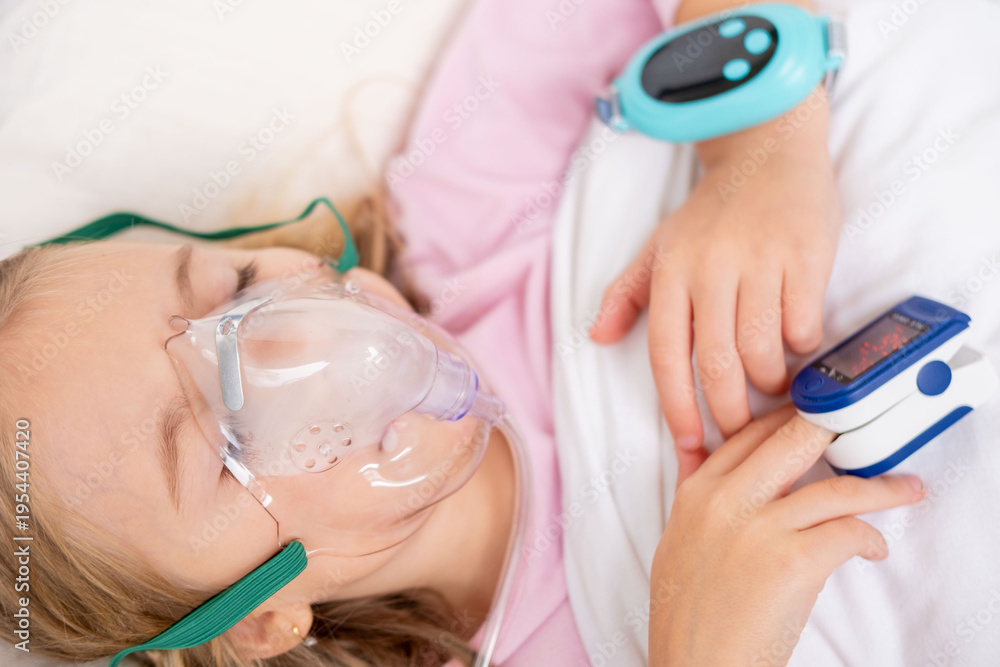 Naklejka premium Young person, girl receiving oxygen therapy, Child lies with oxygen mask and pulse oximeter on finger, patient health tracker, pediatric respiratory care, recovery hospitalization, health monitoring