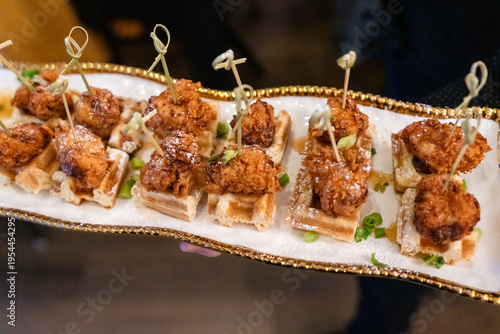 Obraz na plátně Elegant passed chicken and waffle appetizers on serving platter at wedding recep