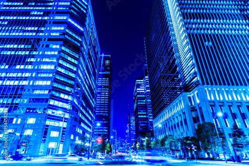 Futuristic business district in Tokyo at night with cyber-blue lights and high-speed motion blur.