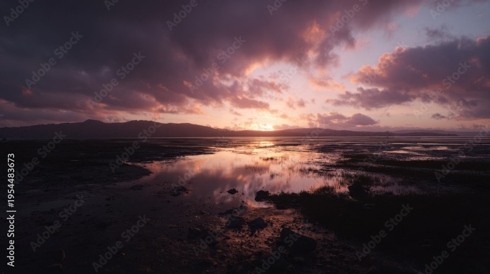 Fototapeta premium Breathtaking Sunset Over Quiet Marshland with Calm Water Reflection and Colorful Sky in Tranquil Nature Scene