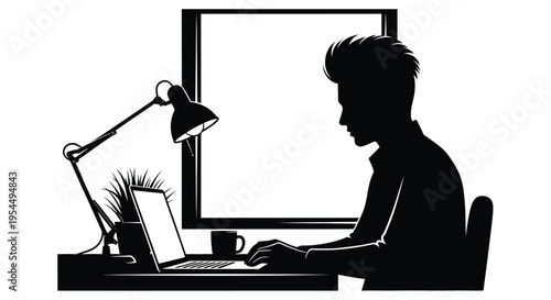 Silhouette of a person working on a laptop at a desk with a lamp