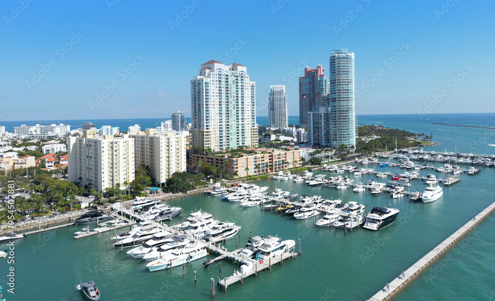 Fototapeta premium Miami Beach with yachts and marina. Marina in Miami Beach Florida with boats. Miami Beach marina and Biscayne Bay. Aerial drone view of Miami Beach marina with luxury yachts.