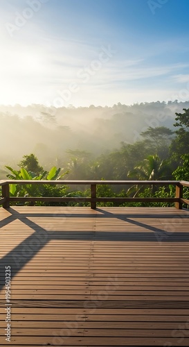 Wooden deck overlooking a misty tropical jungle landscape at sunrise