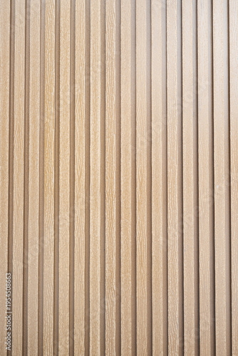 Modern wooden lath background for interior design and architecture.   Light brown wood slat wall panel texture