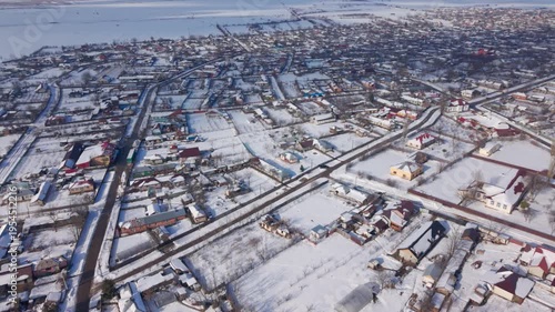 erial drone view of countryside village during snowstorm in Romania