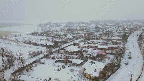 erial drone view of countryside village during snowstorm in Romania