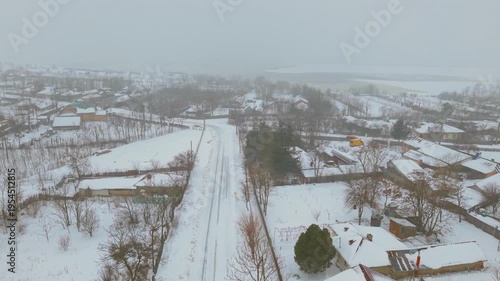 erial drone view of countryside village during snowstorm in Romania