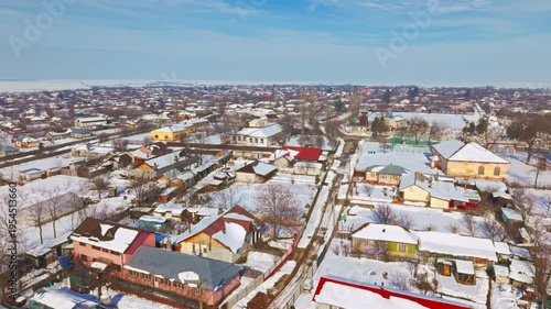 erial drone view of countryside village during snowstorm in Romania