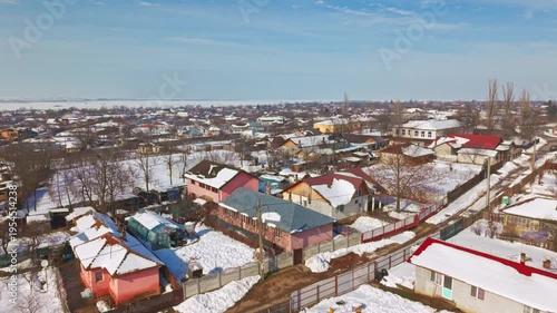erial drone view of countryside village during snowstorm in Romania