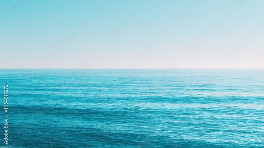 Fototapeta premium Serene Blue Ocean Waves Under Bright Sky with Calm Horizon on a Tranquil Day in Tropical Paradise