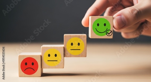 Hand placing wooden block with green happy face on a staircase aspect ratio 16 9