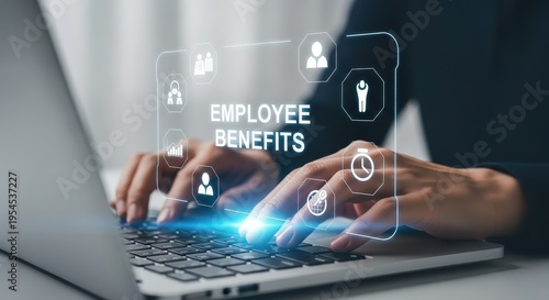 Person typing on laptop with holographic employee benefits interface aspect ratio 16 9 2