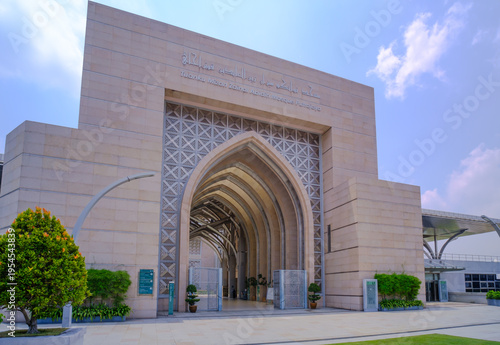 Obraz na płótnie The front main entrance of the Tuanku Mizan Zainal Abidin Mosque known as Iron Mosque featuring decorative stone archway, and modern stainless steel structural elements under a blue sky