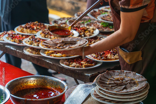 Obraz na plátně Street food vendor serving sliced meat with spicy sauce