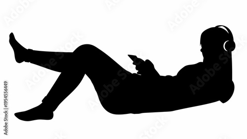 Silhouette of a Relaxed Person Wearing Headphones and Using a Smartphone in a Reclined Position