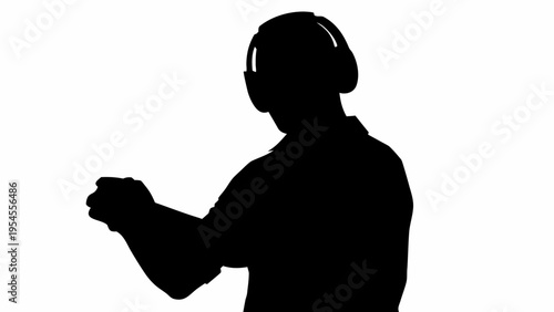 Black silhouette of a man wearing virtual reality headset and interacting with a controller