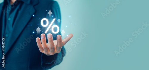 Obraz na płótnie Business person holding glowing percentage symbol with rising arrows representing increasing interest rates, financial growth, investment returns, and economic performance in modern digital finance