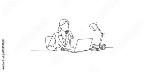 Woman sitting at desk working on laptop with thoughtful expression and office lamp