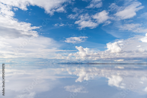 Serene cloud reflection on uyuni salt flat vast landscape in bolivia