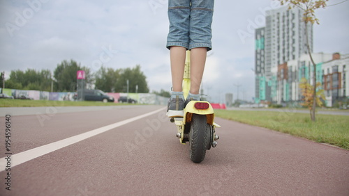 Child Riding Electric Scooter on City Road Outdoors, have fun and enjoy